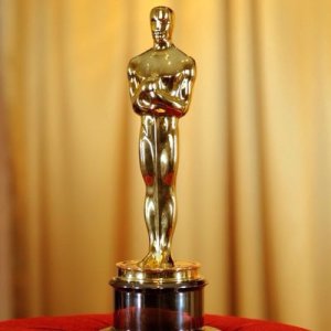 It looks like an Oscar, except the little golden dude is holding a gun to the head of an actor’s child.